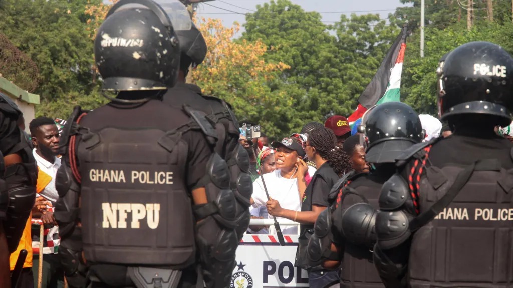 A photo showing a peaceful protest or a political rally with the Ghanaian flag.