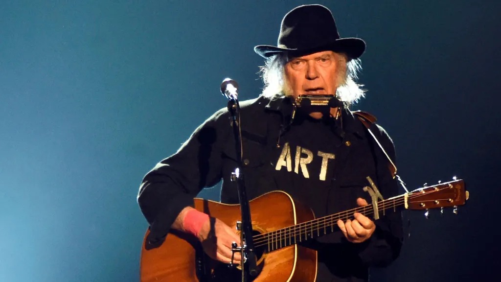 Neil Young performing on the Pyramid Stage at Glastonbury.